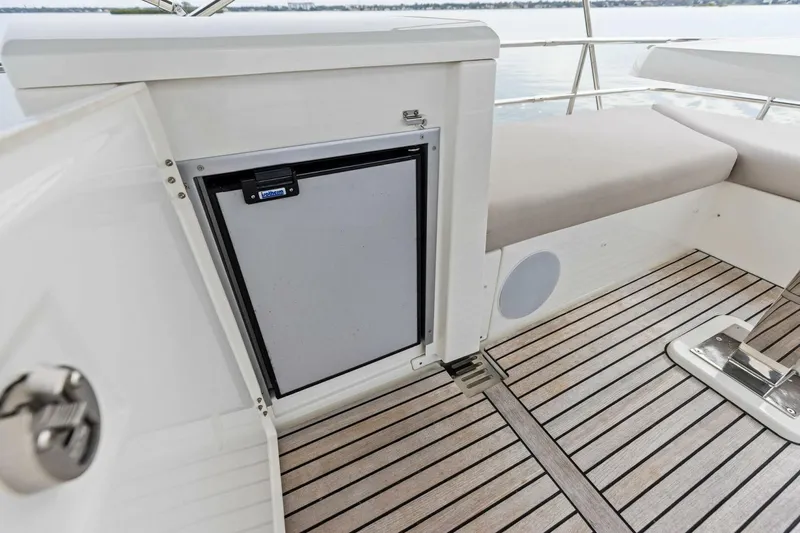 Slide: The Image of 2022 Prestige 420 yacht interior with sleek seating and built-in storage on a wooden deck. - 44