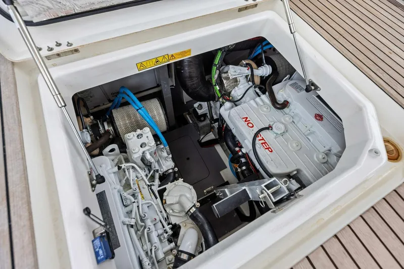 Slide: The Image of Engine compartment of 2022 Prestige 420 yacht, showcasing mechanical components and "No Step" warning. - 46