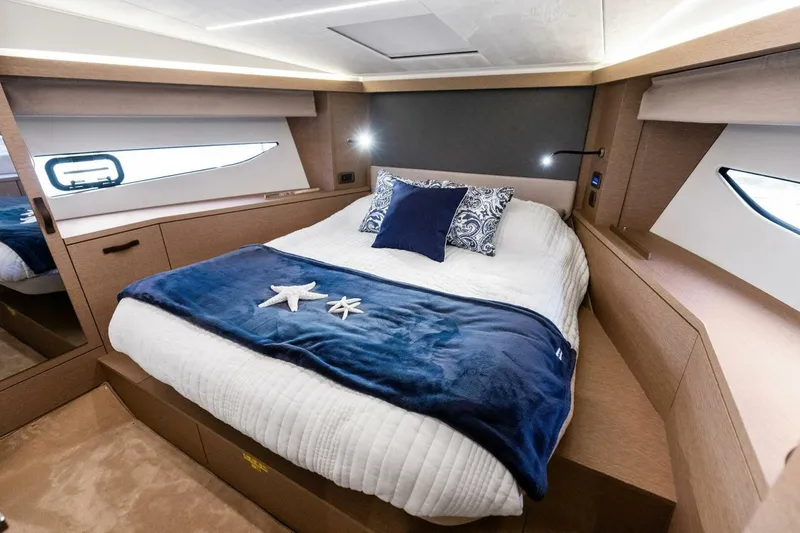 Slide: The Image of Luxurious cabin interior of 2022 Prestige 420 yacht with cozy bedding and elegant decor. - 5