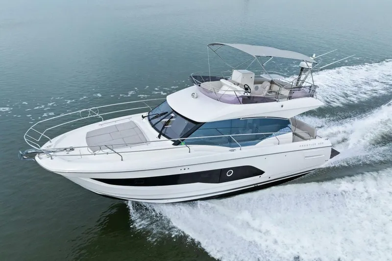 Slide: The Image of 2022 Prestige 420 yacht cruising on open water, showcasing sleek design and luxury features. - 60
