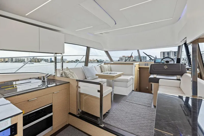 Slide: The Image of Luxurious interior of 2022 Prestige 420 yacht with modern kitchen and seating area. - 7