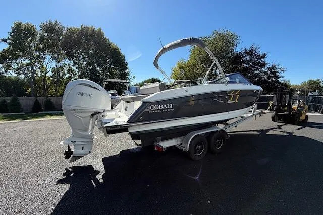 Slide: The Image of 2025 Cobalt R4 Outboard boat on trailer, parked outdoors under clear sky. - 3