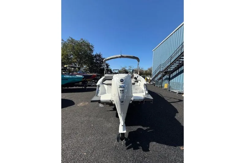 Slide: The Image of 2025 Cobalt R4 Outboard boat with 300 HP engine, parked outdoors. - 6