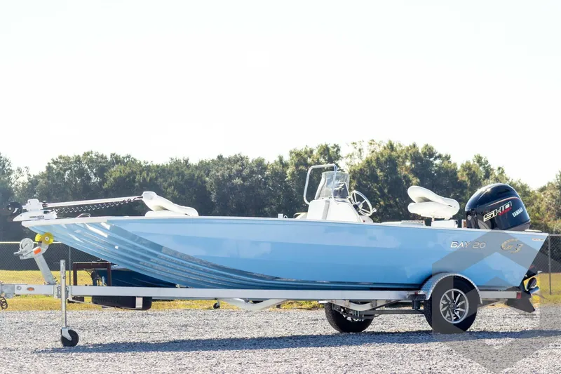 The Image of 2026 G3 Bay 20 boat on trailer, blue hull, Yamaha engine, outdoor setting. - 1