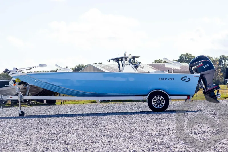 Slide: The Image of 2026 G3 Bay 20 boat on trailer with Yamaha outboard motor, parked outdoors. - 10