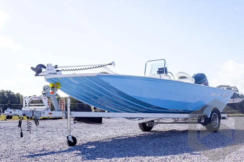 Slide: The Image of 2026 G3 Bay 20 boat on trailer, blue hull, parked on gravel. - 11