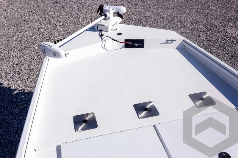 Slide: The Image of Bow of 2026 G3 Bay 20 boat with mounted trolling motor on gravel surface. - 24