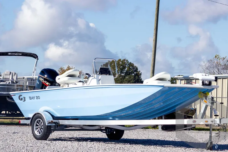 Slide: The Image of 2026 G3 Bay 20 boat on trailer, displayed outdoors under cloudy sky. - 3