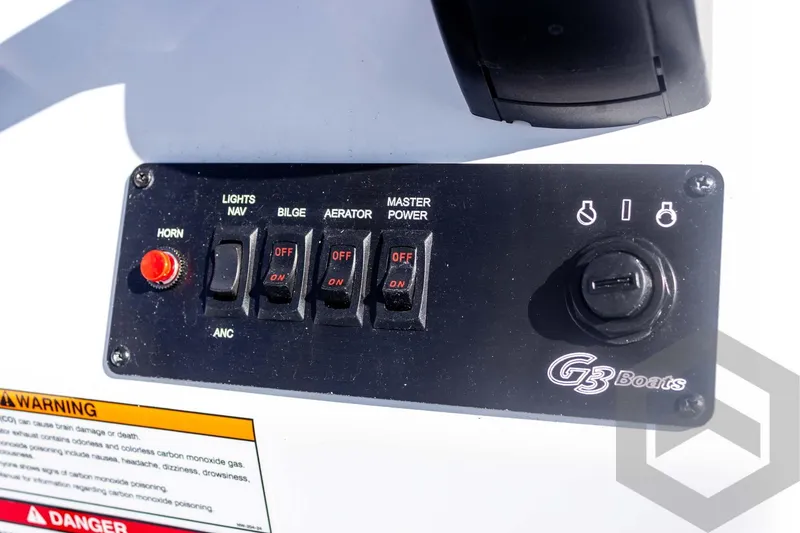 Slide: The Image of Control panel of 2026 G3 Bay 20 boat with switches and warning label. - 34