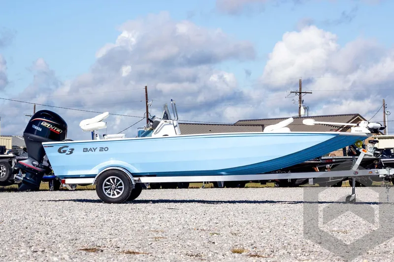 Slide: The Image of 2026 G3 Bay 20 boat with Yamaha engine on trailer, under blue sky. - 4