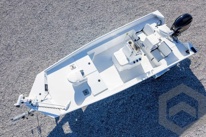 Slide: The Image of 2026 G3 Bay 20 boat, aerial view on gravel, featuring modern design and outboard motor. - 44