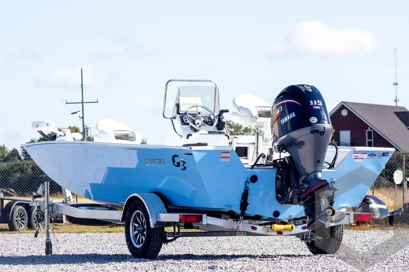 Slide: The Image of 2026 G3 Bay 20 boat with Yamaha motor on a trailer, outdoors. - 9