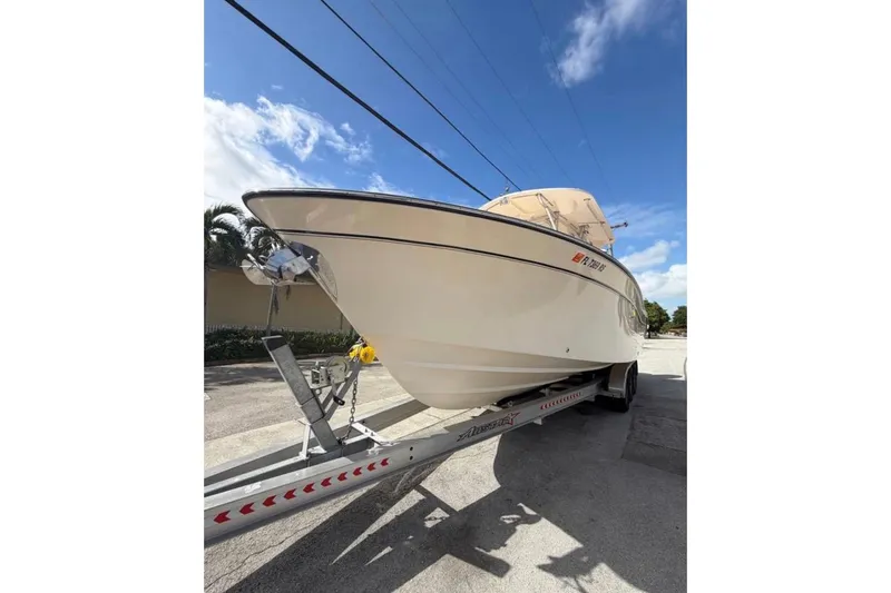 The Image of 2007 Grady-White Bimini 306 boat on trailer under clear blue sky. - 0