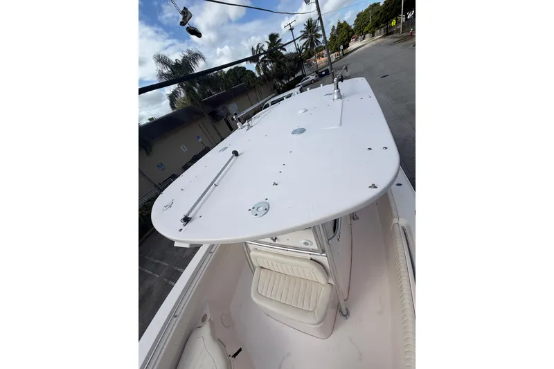 Slide: The Image of 2007 Grady-White Bimini 306 boat with T-top and seating, parked outdoors. - 17