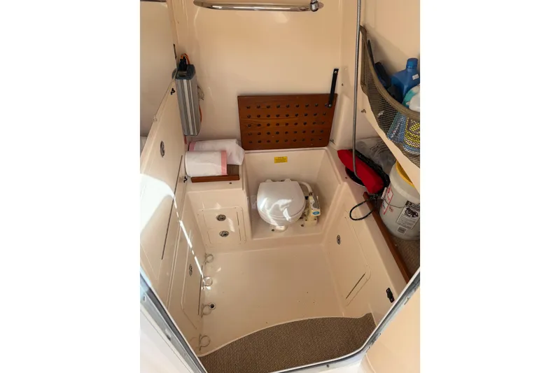 Slide: The Image of 2007 Grady-White Bimini 306 boat interior with storage and marine toilet. - 26