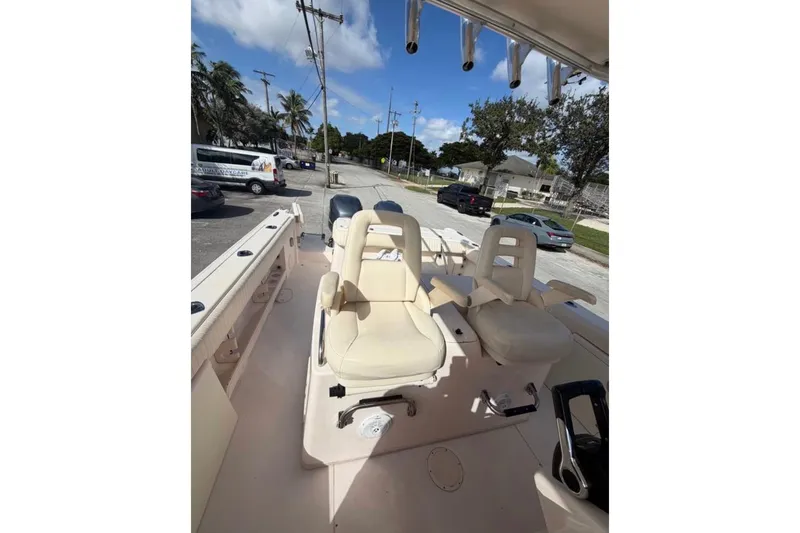 Slide: The Image of 2007 Grady-White Bimini 306 boat interior with dual captain chairs and rod holders. - 3