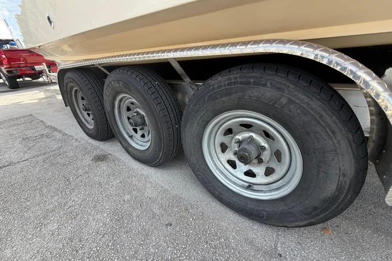 Slide: The Image of Trailer wheels of a 2007 Grady-White Bimini 306 boat on pavement. - 36