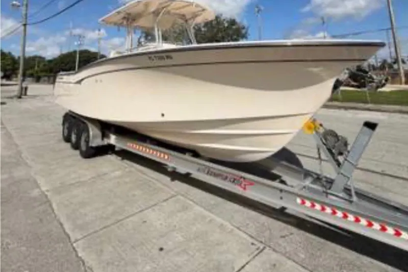 Slide: The Image of 2007 Grady-White Bimini 306 boat on trailer, parked on a sunny street. - 4