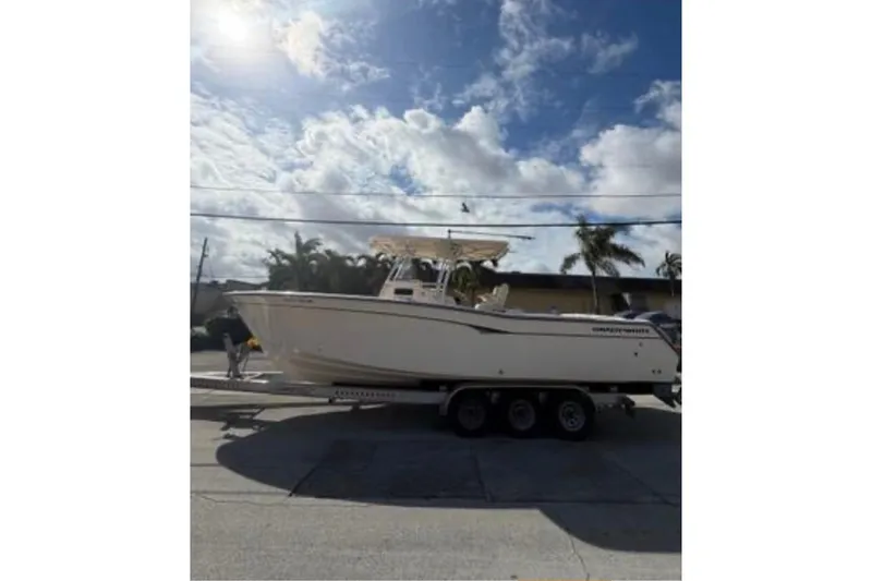 Slide: The Image of 2007 Grady-White Bimini 306 boat on trailer under sunny sky. - 5