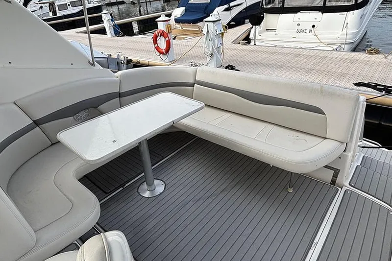 Slide: The Image of 2006 Chaparral Signature 350 boat interior with seating and table, docked at marina. - 12