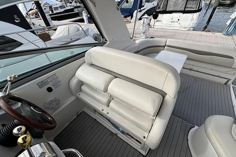 Slide: The Image of 2006 Chaparral Signature 350 boat interior with white seating and steering wheel. - 13