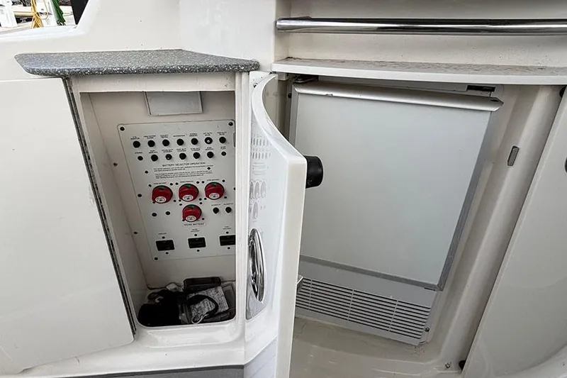 Slide: The Image of 2006 Chaparral Signature 350 boat control panel and storage compartment. - 15