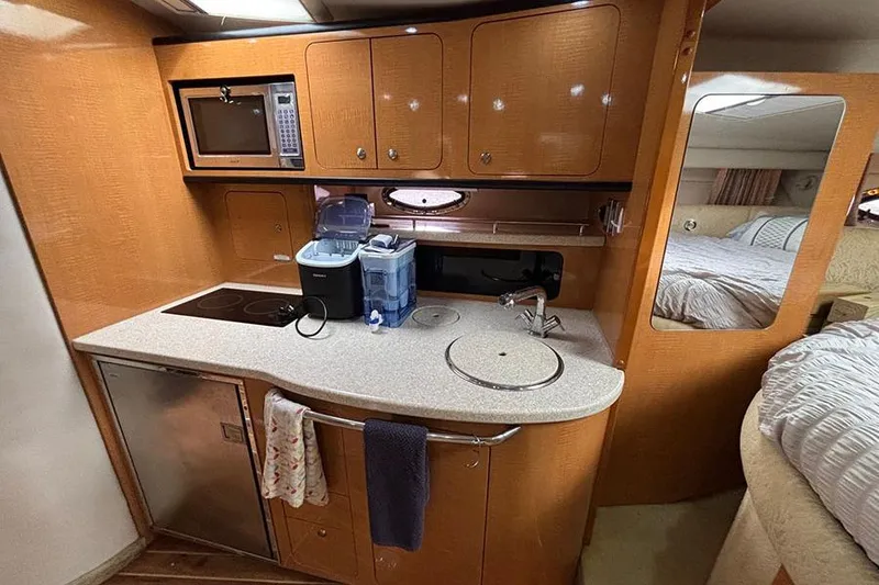 Slide: The Image of 2006 Chaparral Signature 350 yacht interior with kitchenette and cozy bedroom. - 18