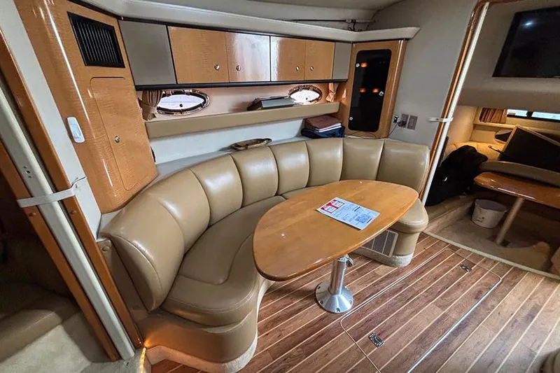 Slide: The Image of 2006 Chaparral Signature 350 yacht interior with leather seating and wooden table. - 19