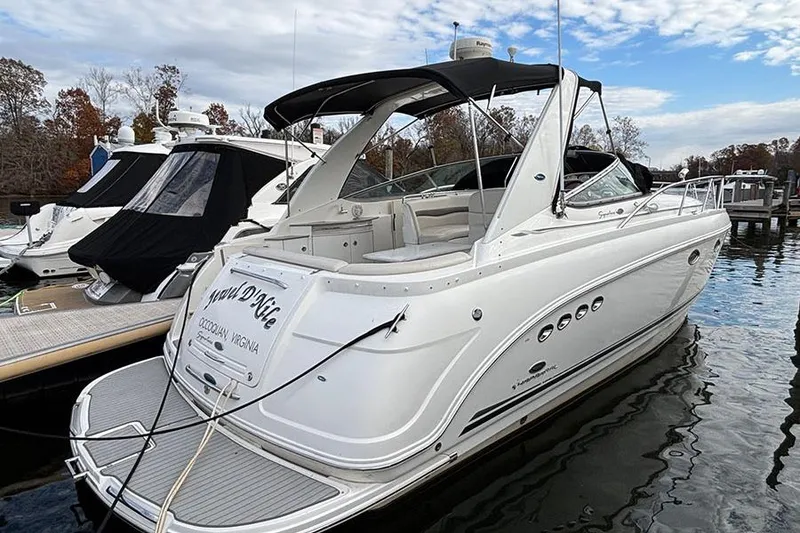 Slide: The Image of 2006 Chaparral Signature 350 boat docked at marina, featuring sleek white design. - 2