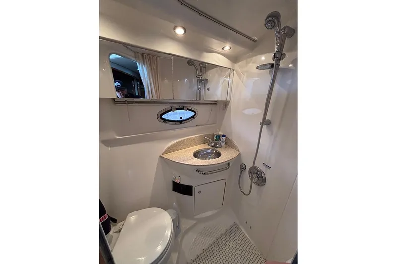 Slide: The Image of 2006 Chaparral Signature 350 bathroom with shower, sink, and toilet in compact design. - 20