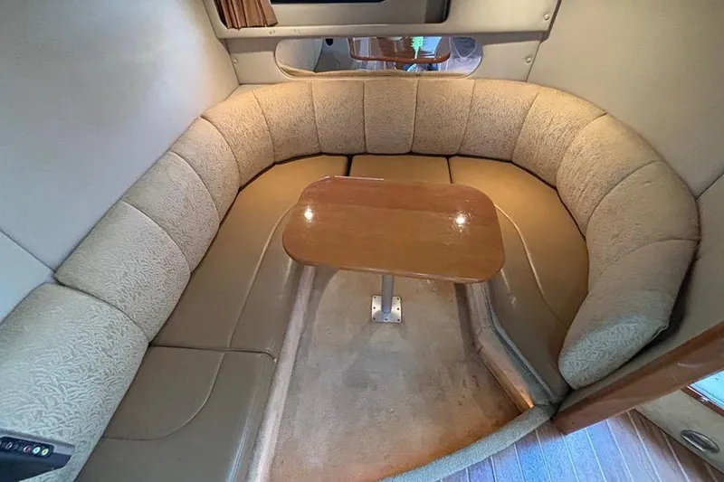 Slide: The Image of 2006 Chaparral Signature 350 interior with curved seating and wooden table. - 24