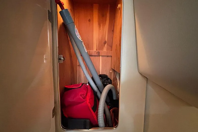 Slide: The Image of Storage compartment in 2006 Chaparral Signature 350 boat with cleaning equipment. - 25