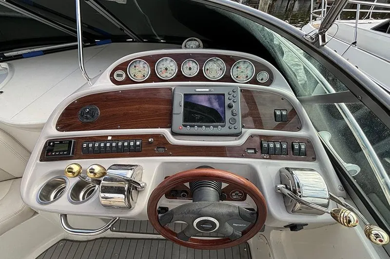Slide: The Image of 2006 Chaparral Signature 350 boat dashboard with gauges, controls, and wood accents. - 5
