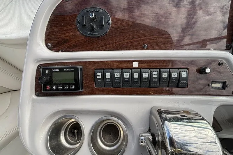 Slide: The Image of Control panel of 2006 Chaparral Signature 350 boat with switches and stereo system. - 6