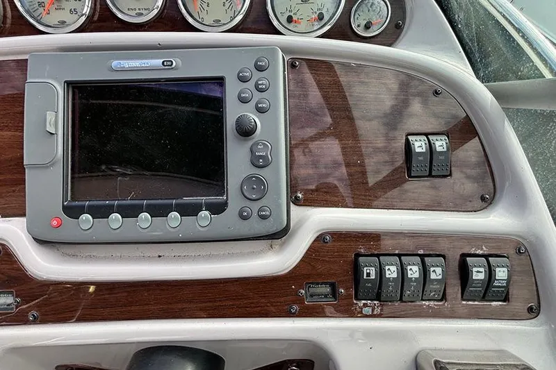 Slide: The Image of Control panel of a 2006 Chaparral Signature 350 boat with gauges and switches. - 7