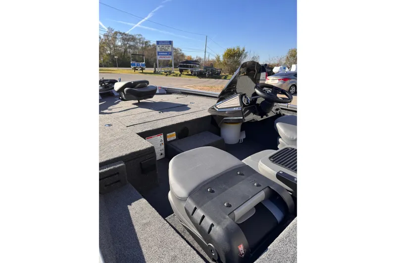 Slide: The Image of 2026 Lowe Stinger 175C boat interior with seating and steering console. - 11