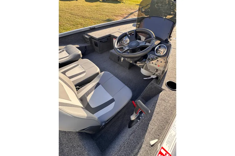 Slide: The Image of 2026 Lowe Stinger 175C boat interior with steering wheel and seats. - 14