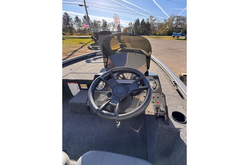 Slide: The Image of 2026 Lowe Stinger 175C boat dashboard with steering wheel and controls. - 15