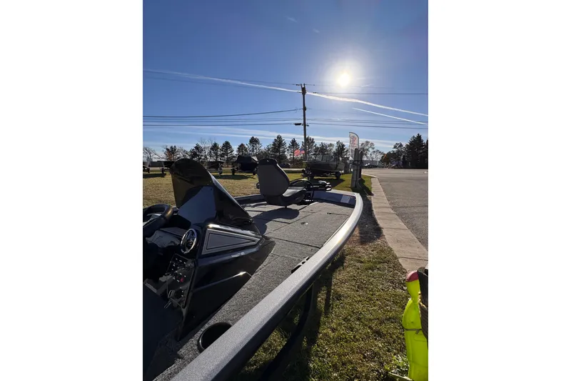 Slide: The Image of 2026 Lowe Stinger 175C boat parked outdoors under clear blue sky. - 16