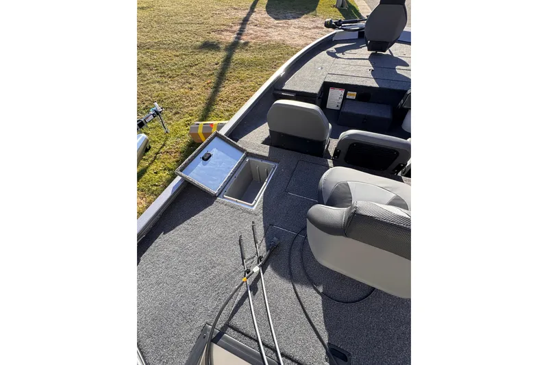 Slide: The Image of 2026 Lowe Stinger 175C boat interior with open storage compartment and seating. - 17