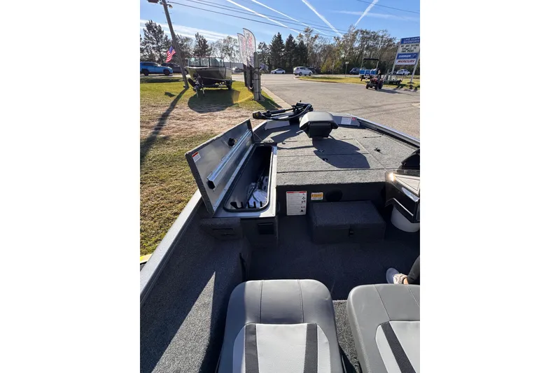 Slide: The Image of 2026 Lowe Stinger 175C boat interior with open storage compartment and seating. - 19