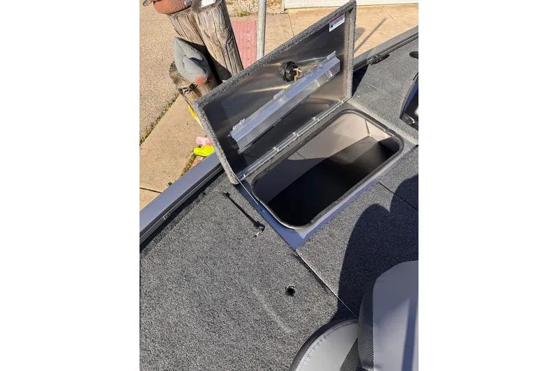 Slide: The Image of Open storage compartment on 2026 Lowe Stinger 175C boat deck. - 20