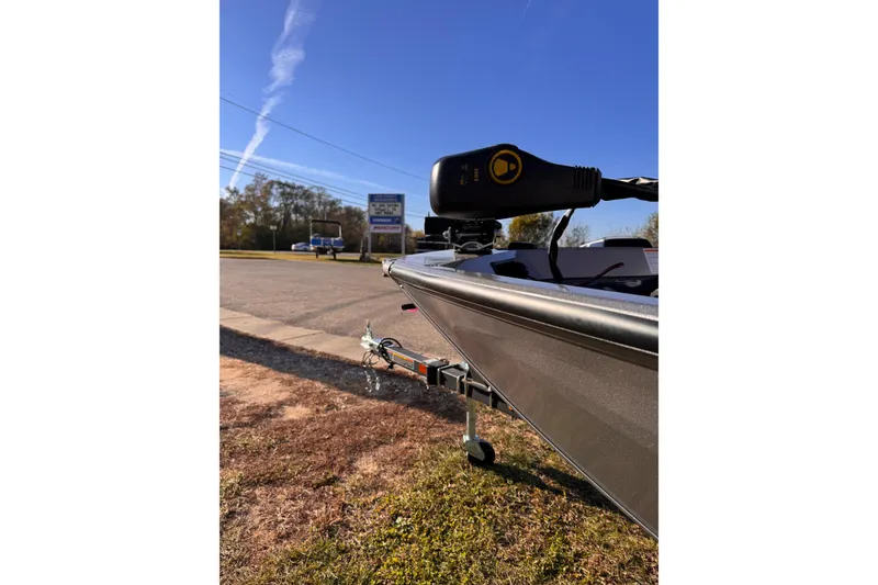 Slide: The Image of 2026 Lowe Stinger 175C boat on trailer, parked outdoors under clear blue sky. - 21
