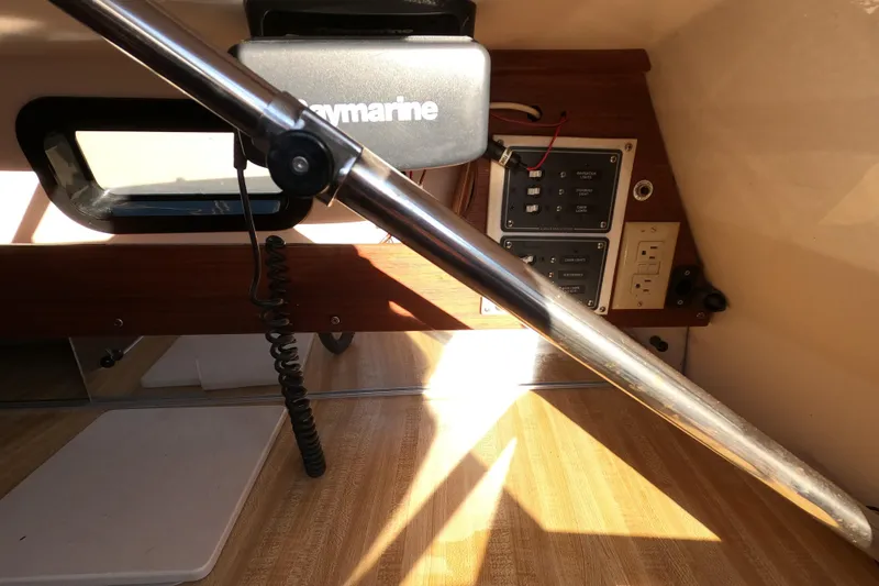 Slide: The Image of Interior of a 1996 Rhodes 22 sailboat with navigation equipment and control panel. - 12