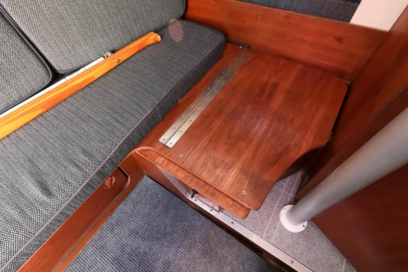 Slide: The Image of 1996 Rhodes 22 interior with wooden table and cushioned seating. - 14