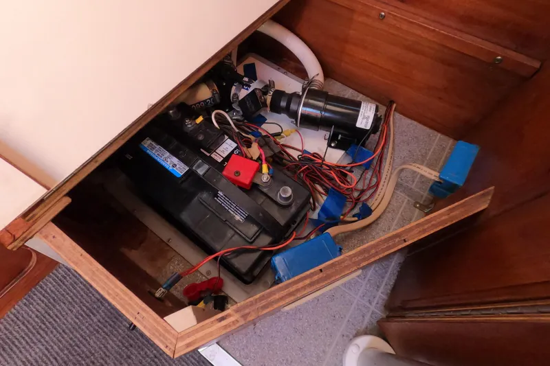 Slide: The Image of Electrical compartment of a 1996 Rhodes 22 boat with battery and wiring. - 15