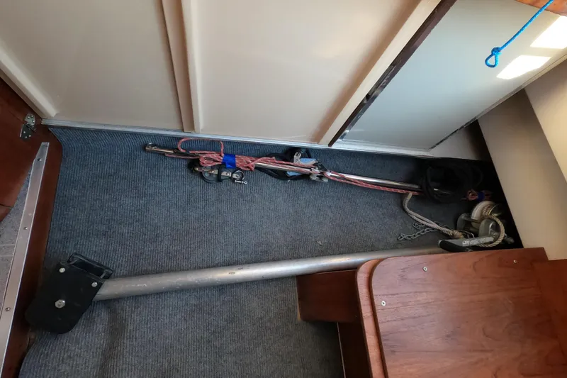 Slide: The Image of Interior of a 1996 Rhodes 22 sailboat with stored sailing equipment. - 18