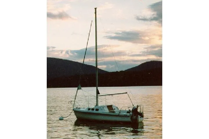 Slide: The Image of Sailboat on tranquil lake at sunset, Rhodes 22 model, 1996. - 21