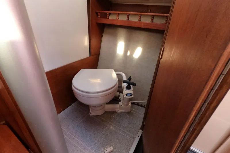 Slide: The Image of Compact marine toilet in a 1996 Rhodes 22 sailboat bathroom. - 9