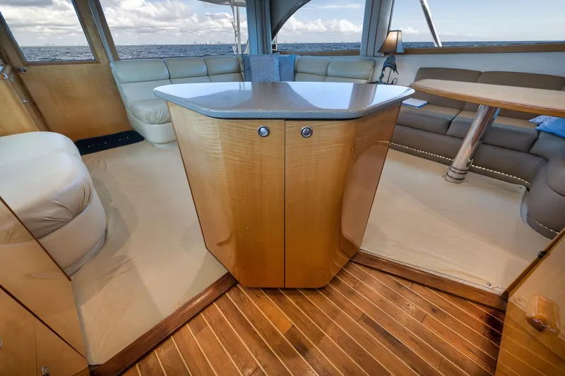 Slide: The Image of Luxurious interior of 2002 Weaver 60 Convertible yacht with elegant wood and leather furnishings. - 12